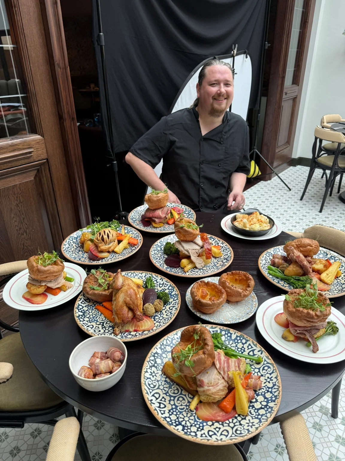 A chef presenting a selection of Sunday lunch dishes