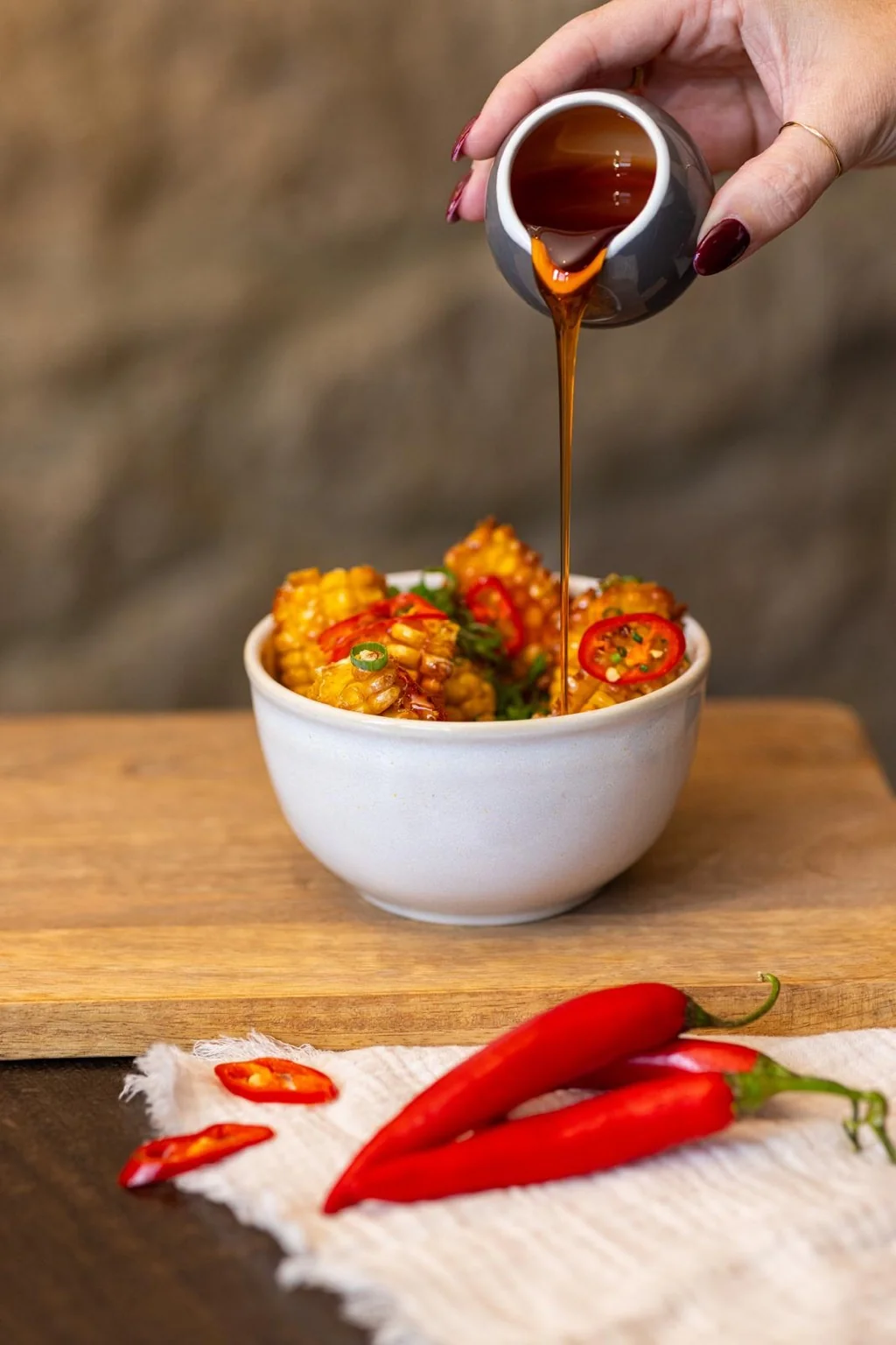 Sauce being poured over golden corn ribs