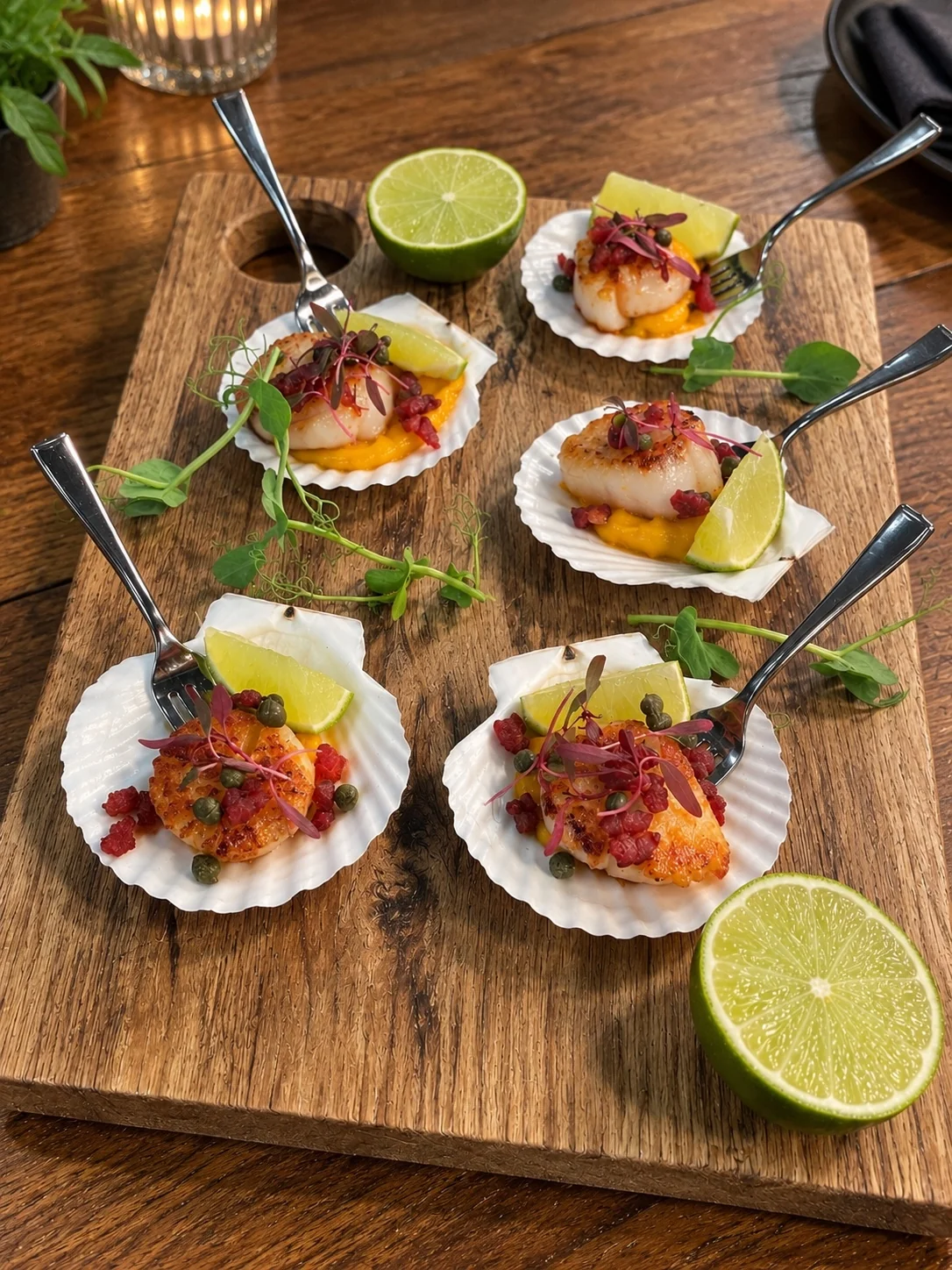 Seared scallops presented in shells with colourful accompaniments